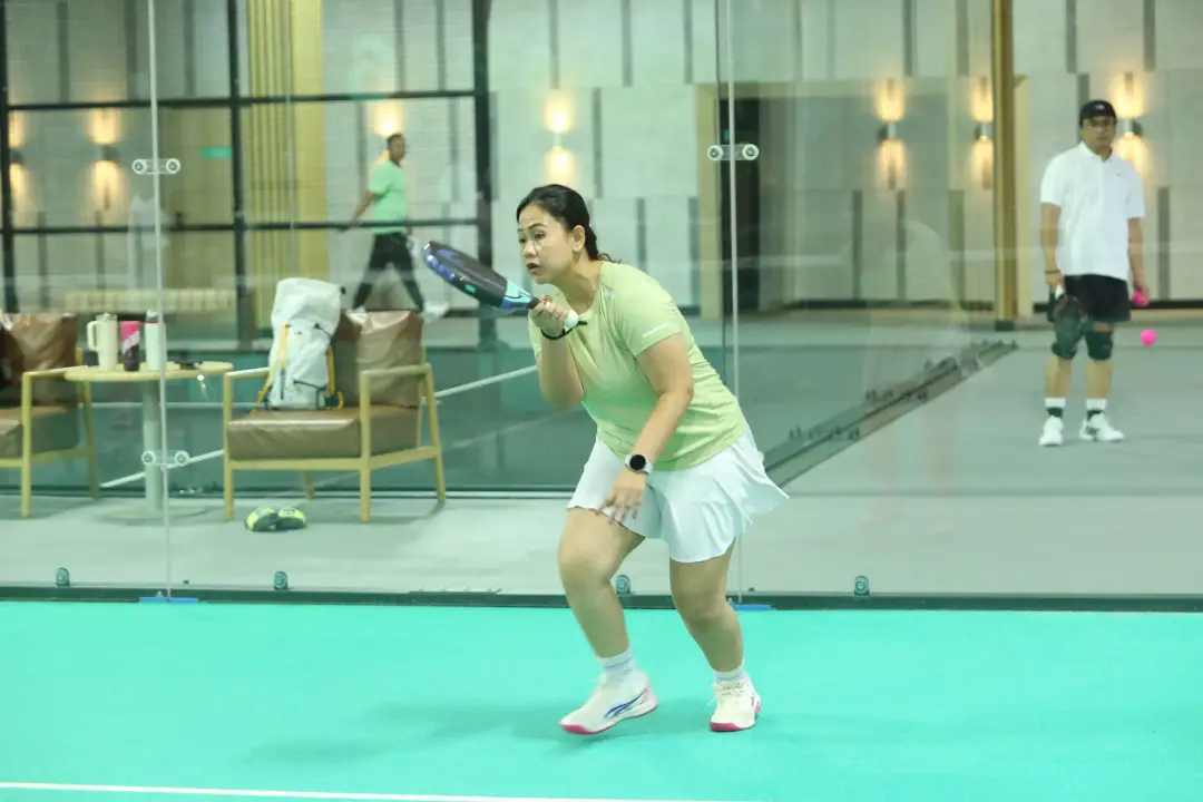Player at the net on teal turf